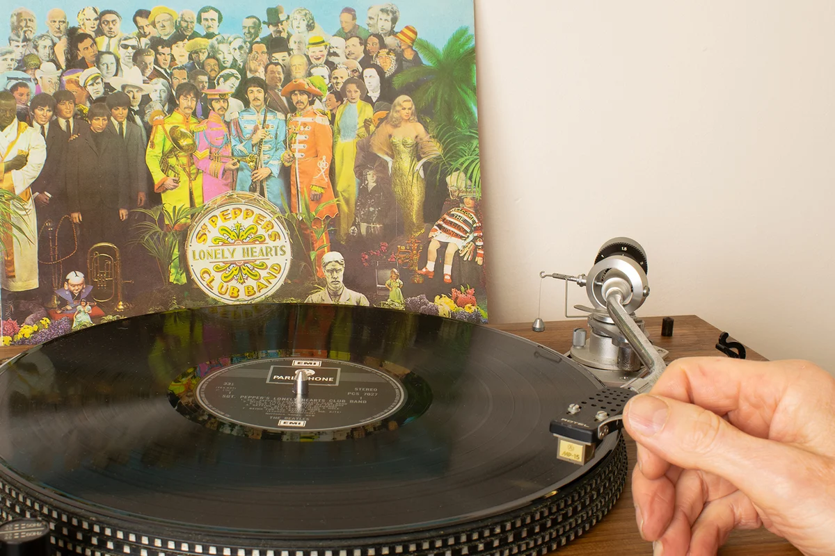 Playing Sgt Pepper's Lonely Hearts Club Band vinyl record by the Beatles