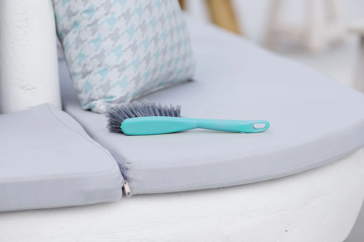 cleaning brush on pillows in cafe bar