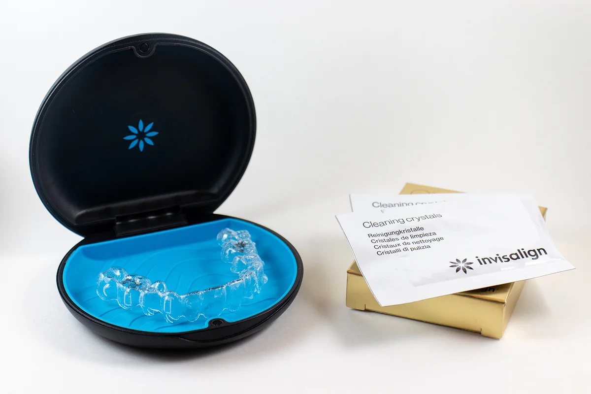 invisalign blue package with a box and cleaning crystals