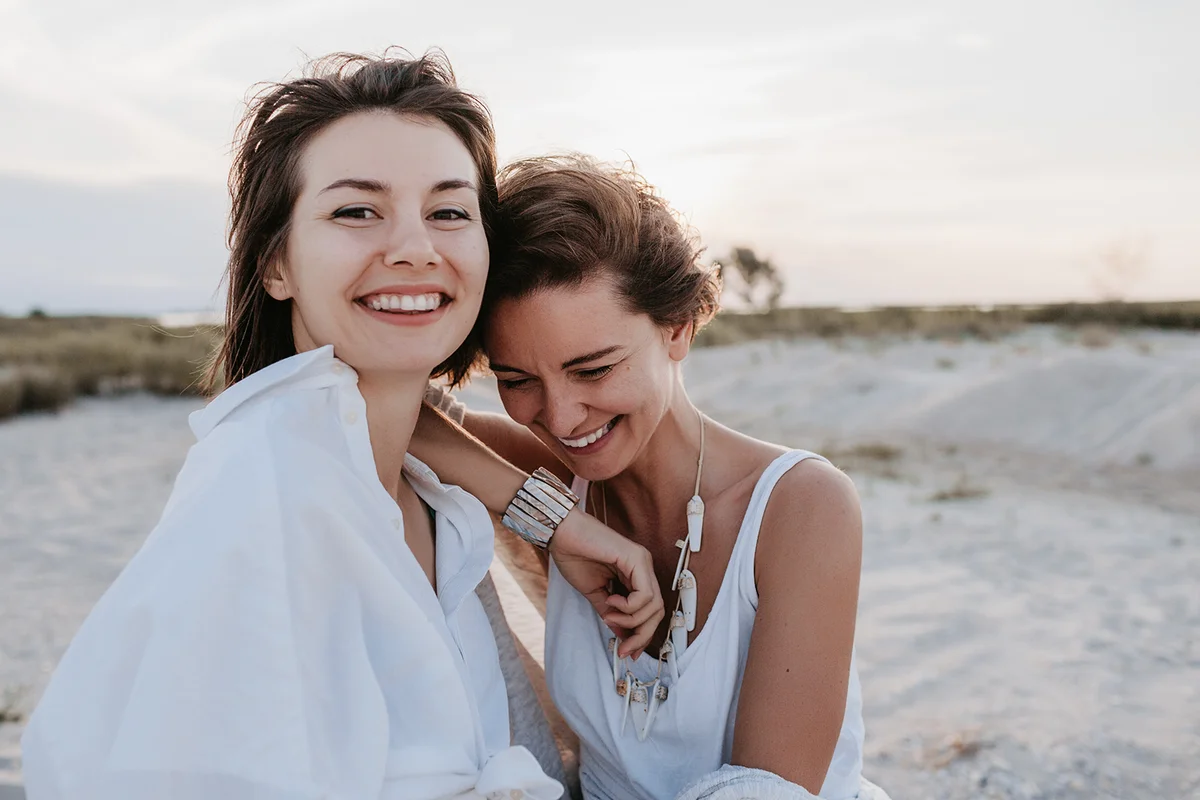 smiling couple having fun on the sunset beach