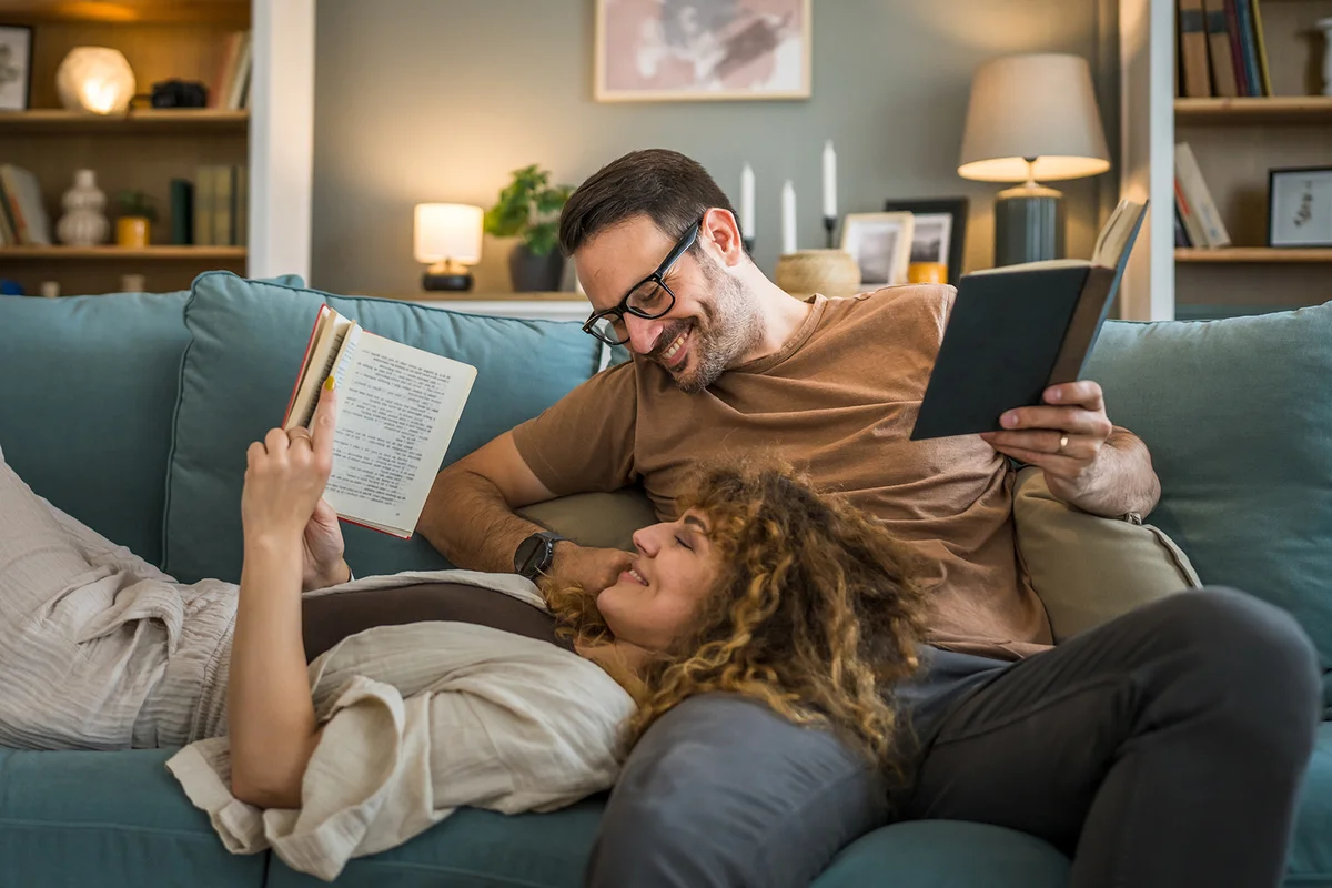 Couple reading books on the sofa bed