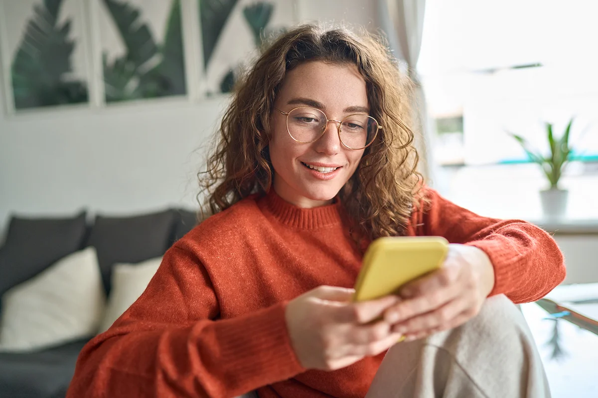 woman texting and smilling
