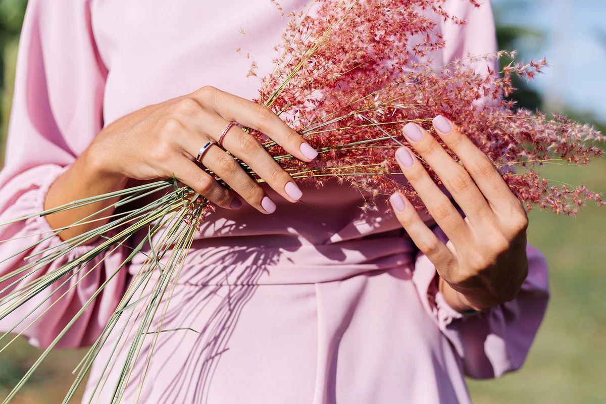 Close shot of romantic cute pink gel polished manicure nails.