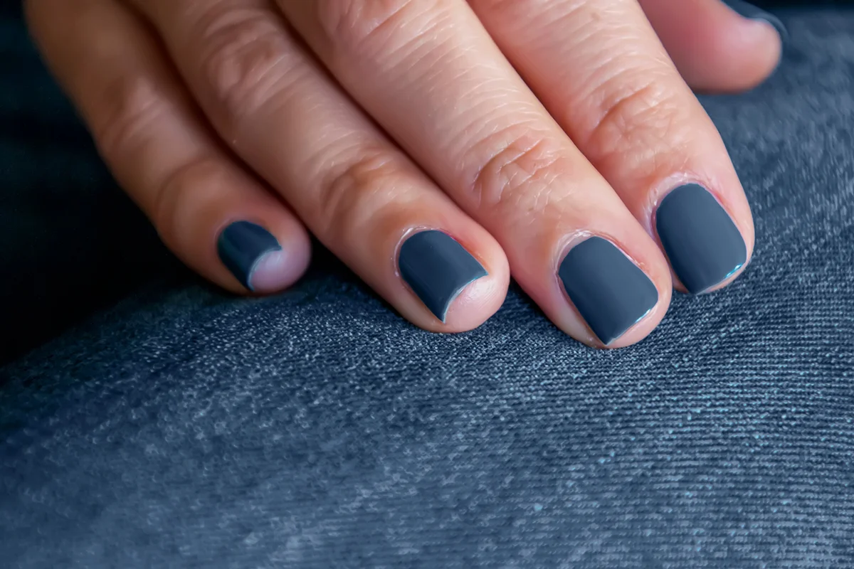 Close Up View Of Woman Blue Nails On Jeans Pants