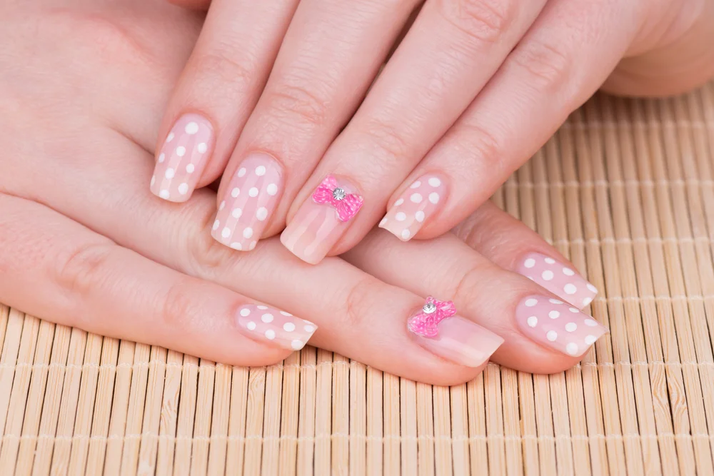 Cute close-up of coquette nails with bow details