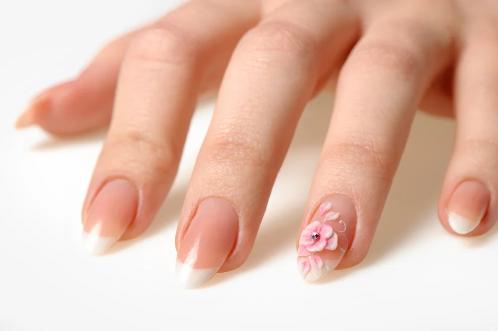French manicure embellished with a single flower