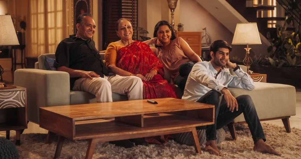 Happy Indian family watching a movie at home