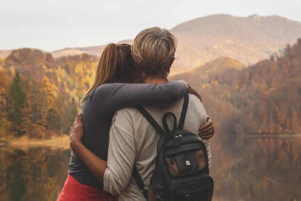 Mother and daughter watching the landscape after a hike