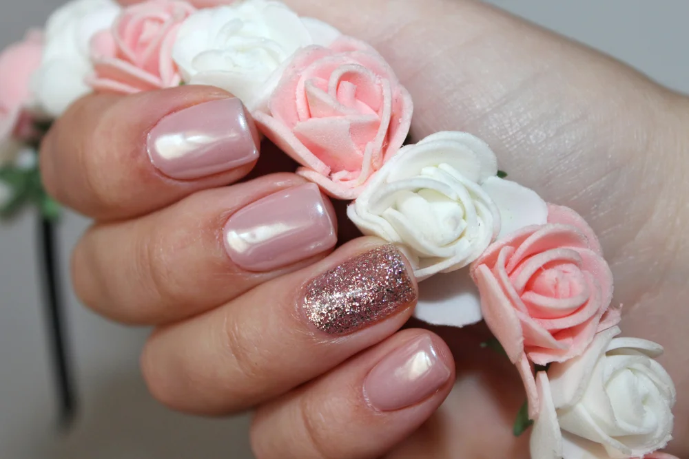 Close-up of a pink and rose gold glitter manicure