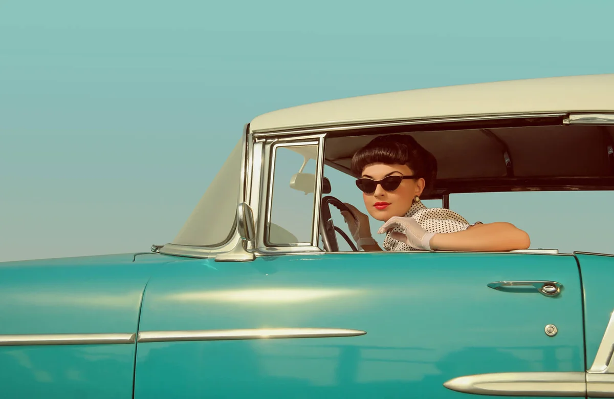Young women driven a car in the 60s