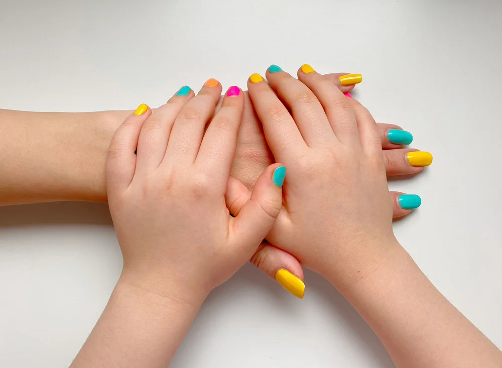 Funny multicolored mom and daughter manicure