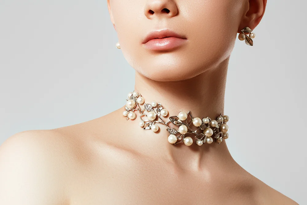 Close-up shot of a woman with a beautiful choker necklace and matching earrings