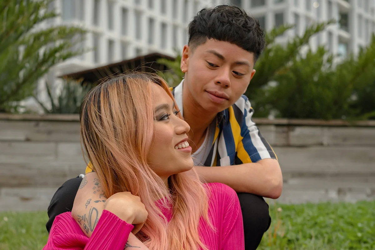 A trans couple enjoying a moment in the park