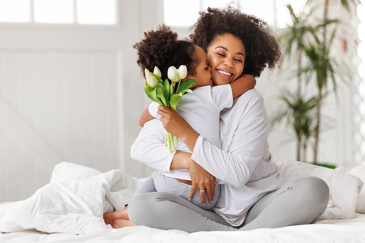 Aunt and nice hugging with flowers