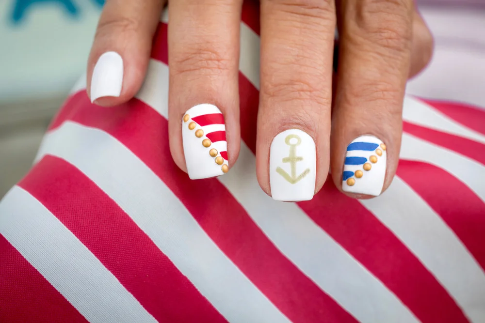 Anchor nautical US Navy-themed manicure with stripes in red, white, gold, and blue