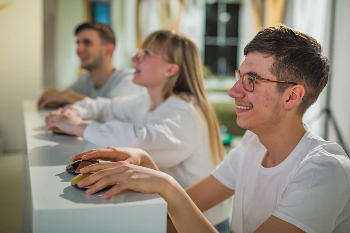 Students at a Quiz Competition with Hands on a Button