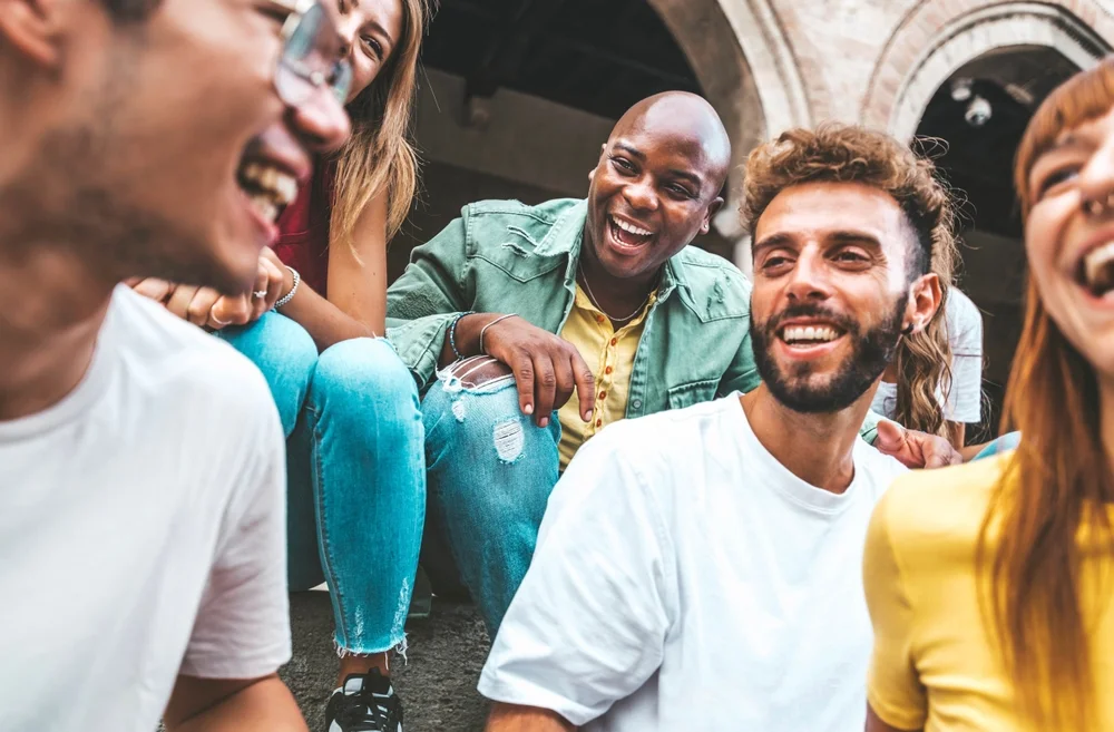 Multiracial group of friends hanging out, laughing