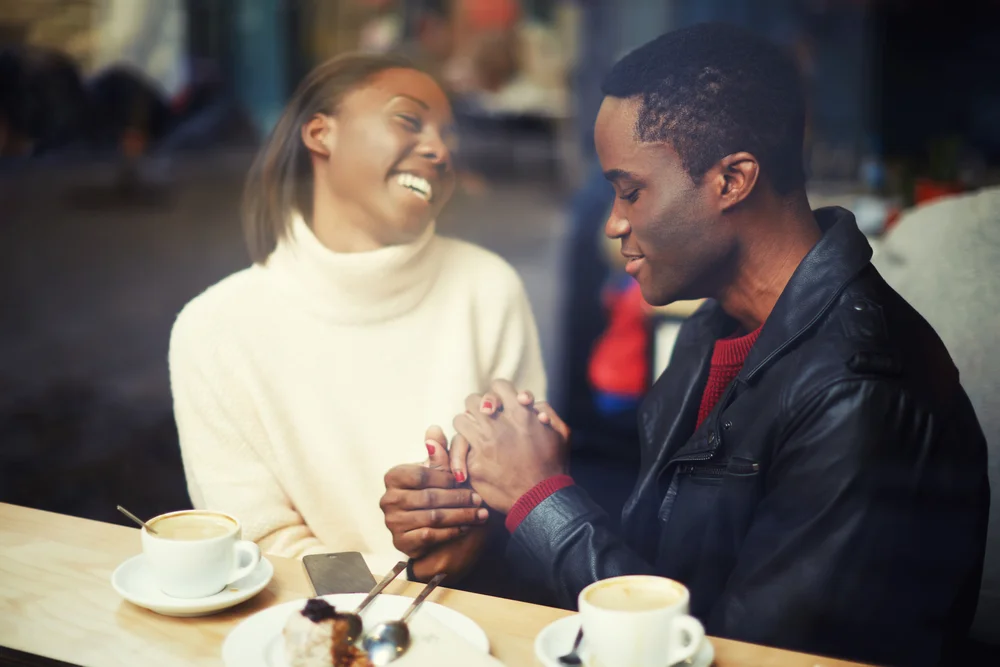 Affectionate Taurus man warming a woman's hands