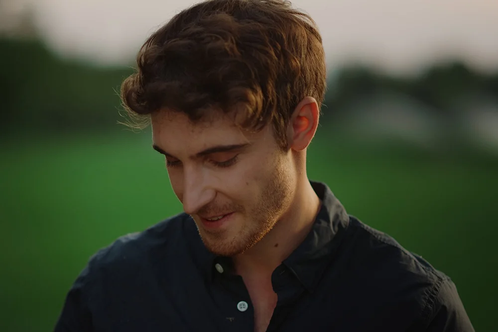 Taurus guy feeling shy and avoiding eye contact outdoors