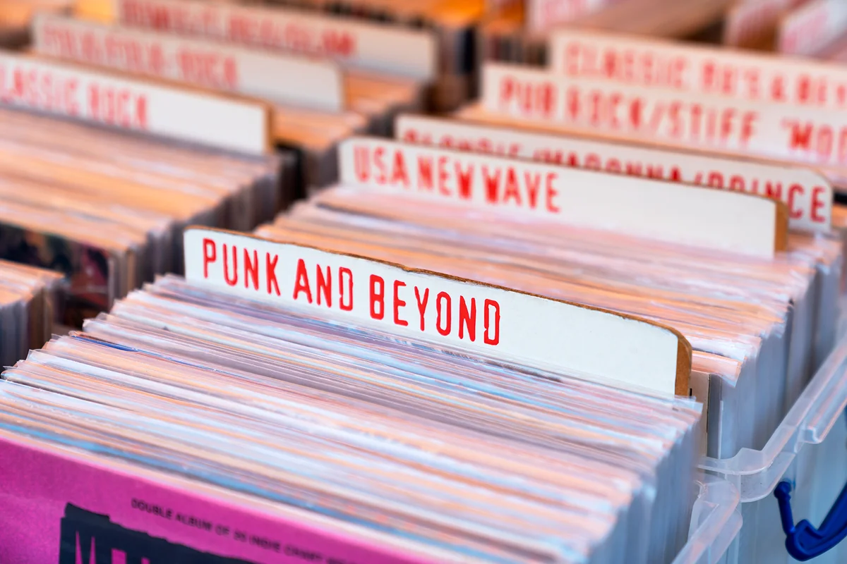 Collection of various vinyl albums for sale in boxes divided into music genres
