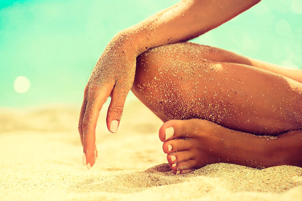 Woman In Relaxation On Tropical Beach with sand , body parts . Tanned girl in Lotus position,yoga, and meditation