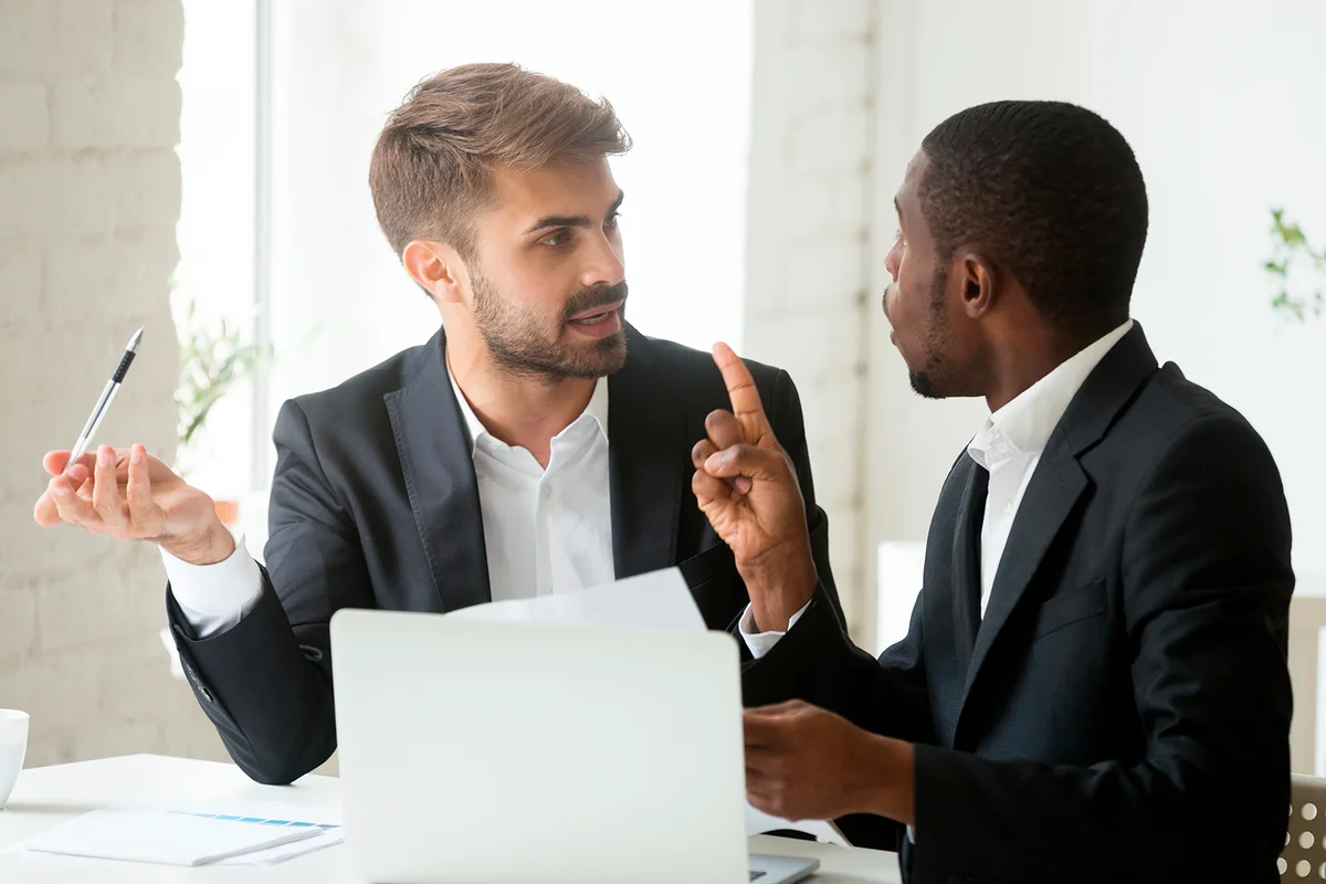 stressed diverse businessmen arguing in office