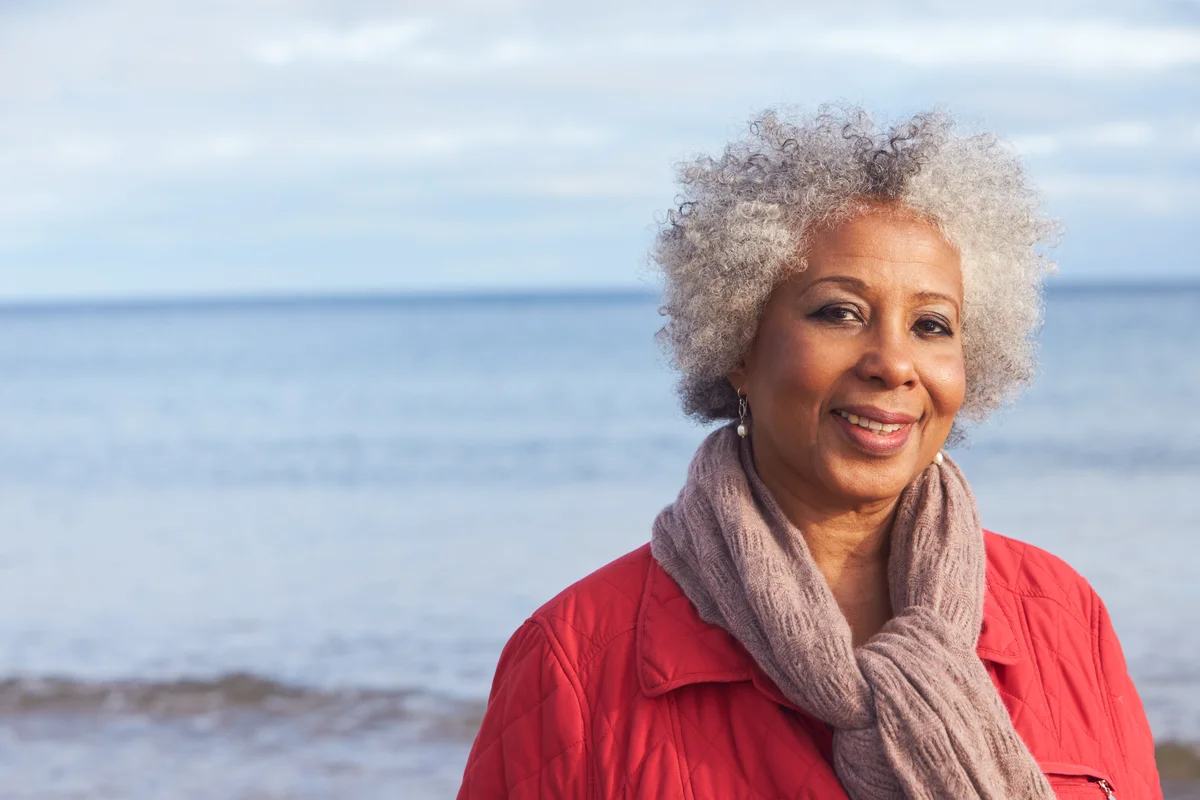 woman with gray hair at the shoreline