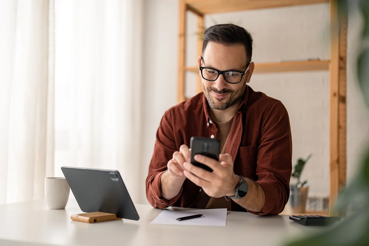 Man smiling and texting