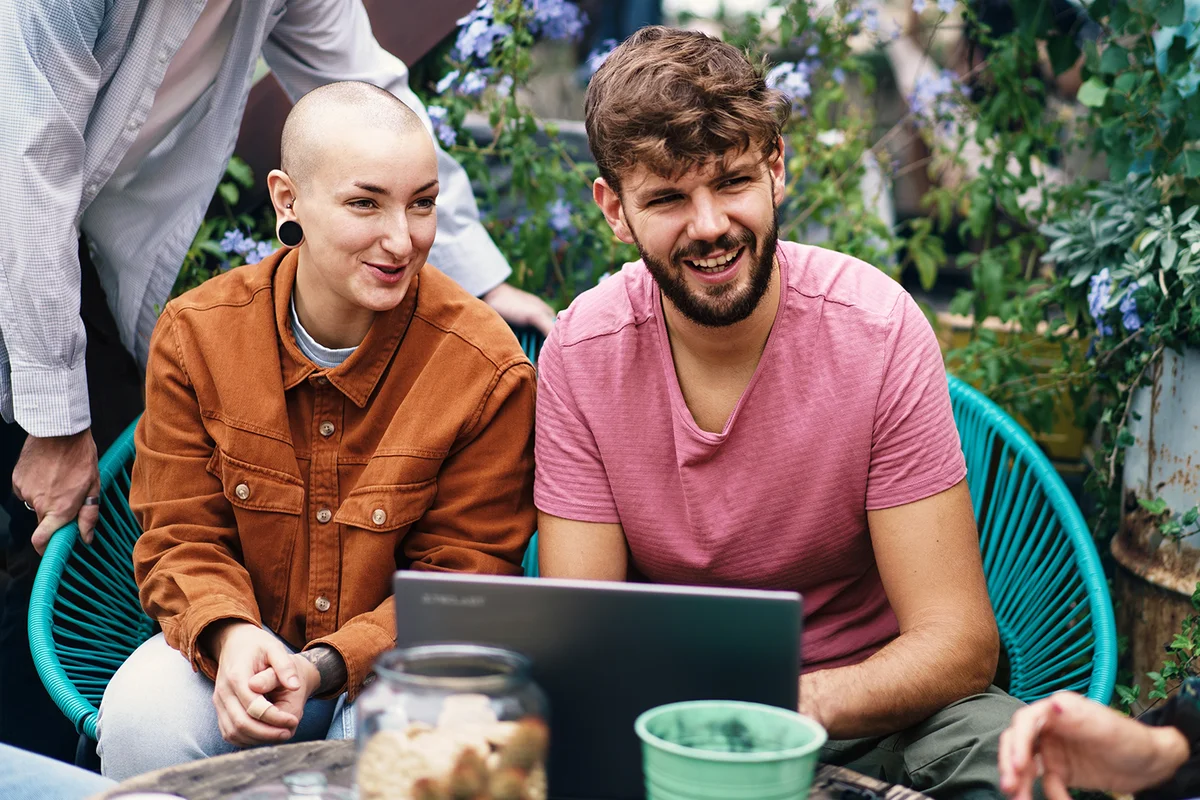 Non-binary Student Engaging in Group Study Outdoors