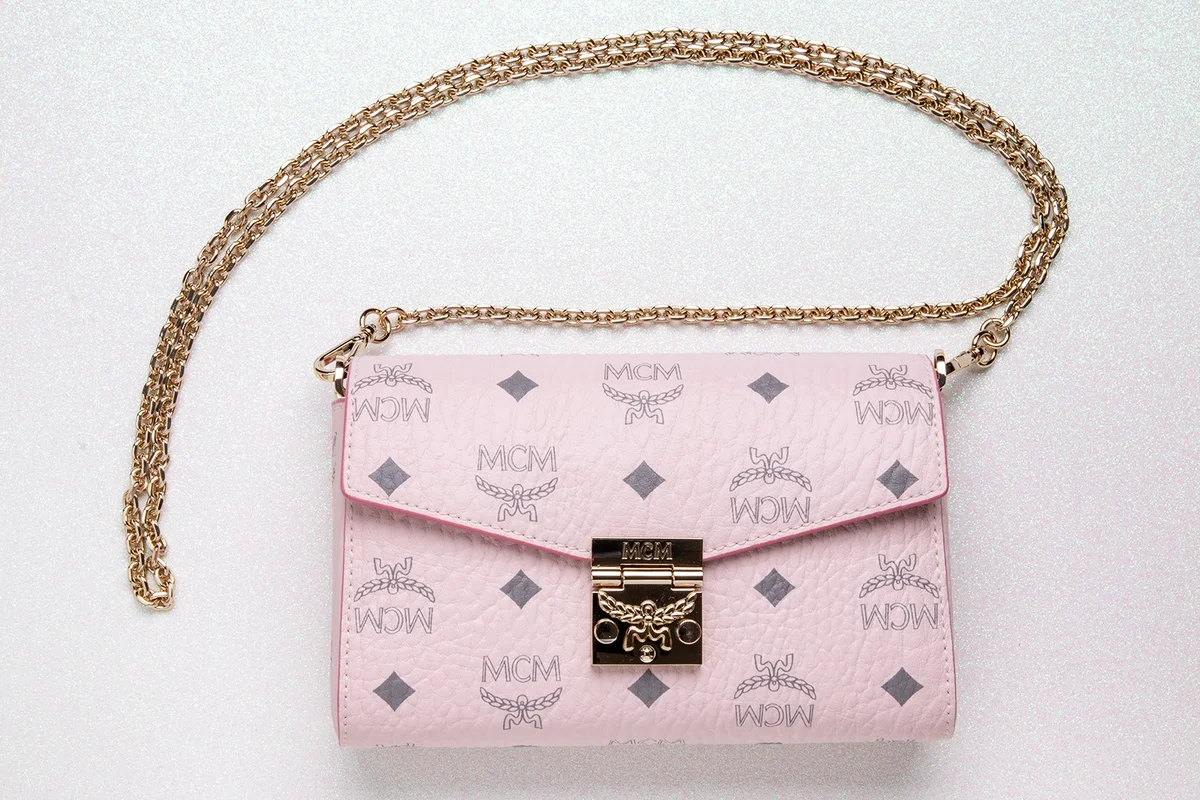 Close-up of luxury expensive light pink MCM leather handbag