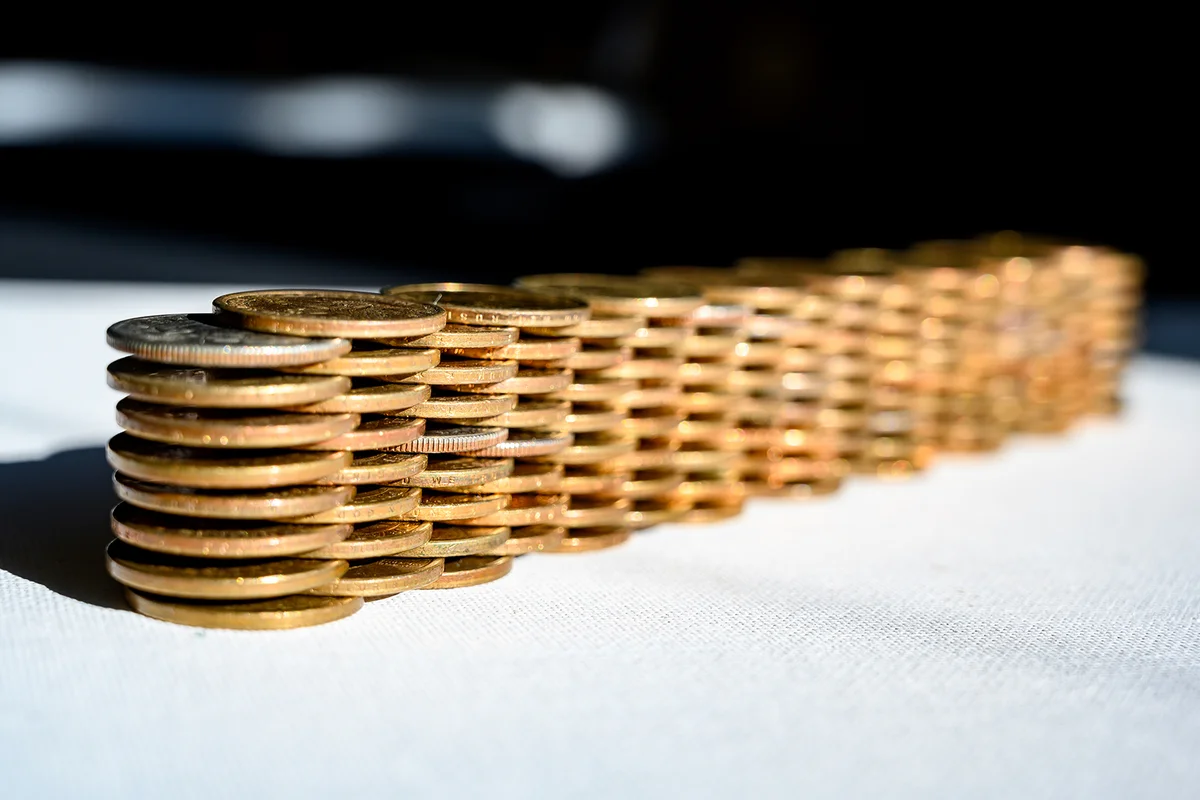 Stack of gold and silver dollar coins