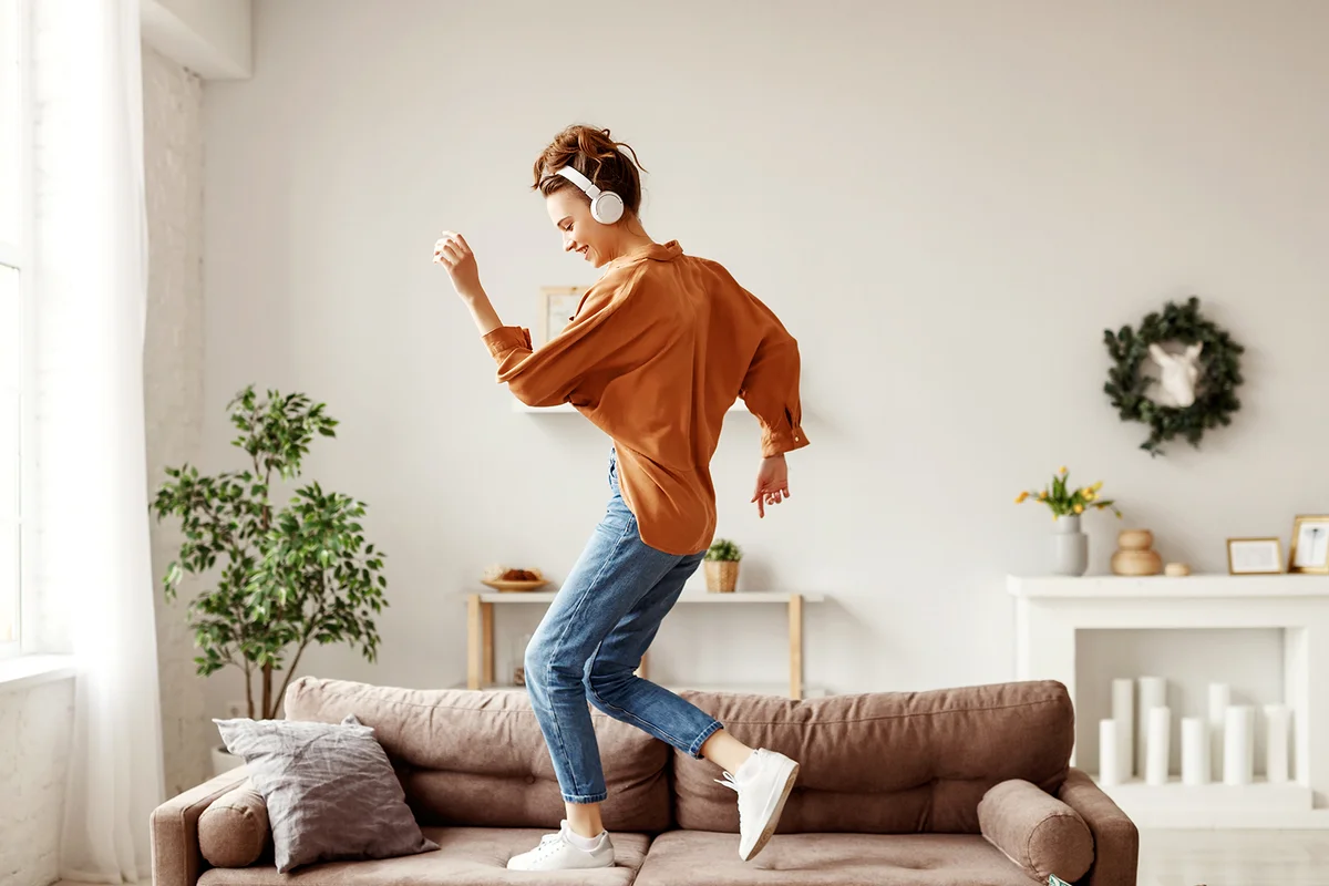 woman listening to music with pleasure and dancing