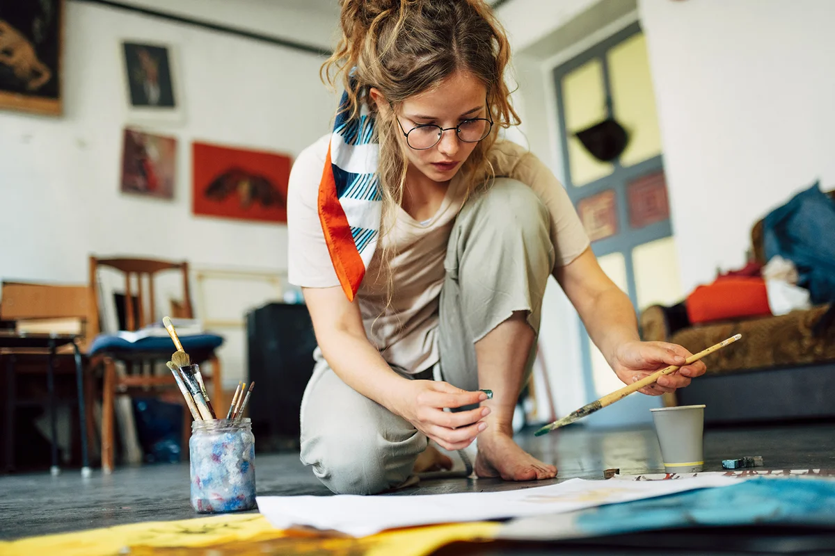female artist sitting on the floor