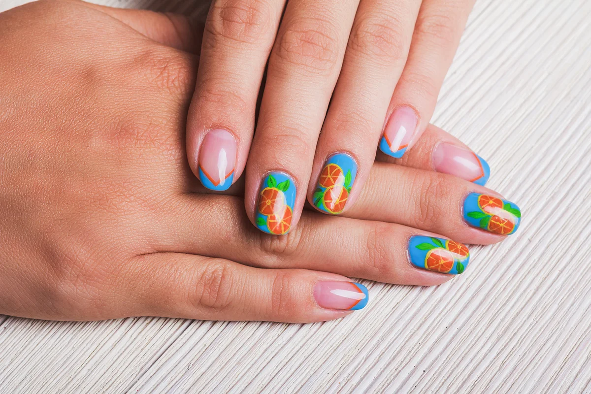 Summer french blue nail art with painted orange fruit
