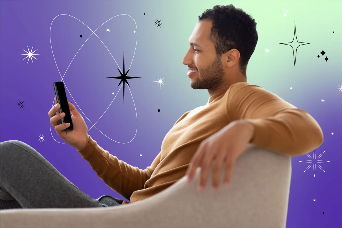man holding mobile phone sitting on the couch