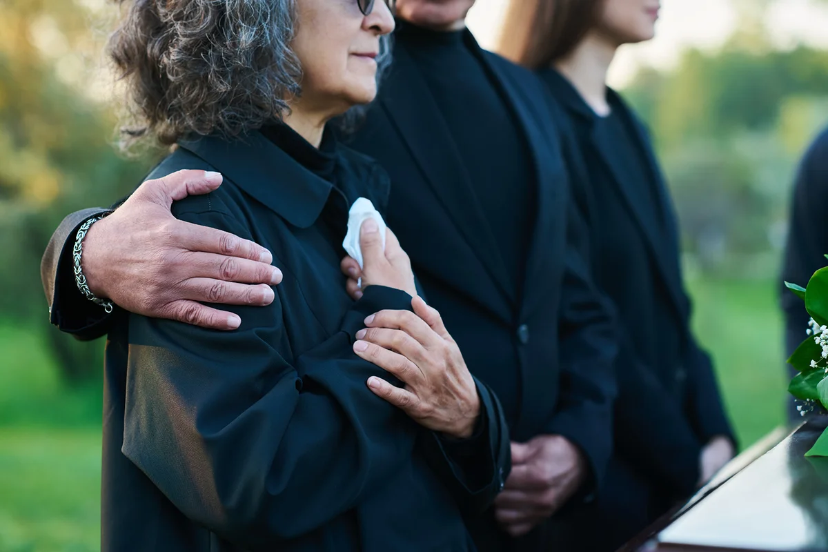 man on shoulder of his sister with handkerchief lamenting passes away spouse