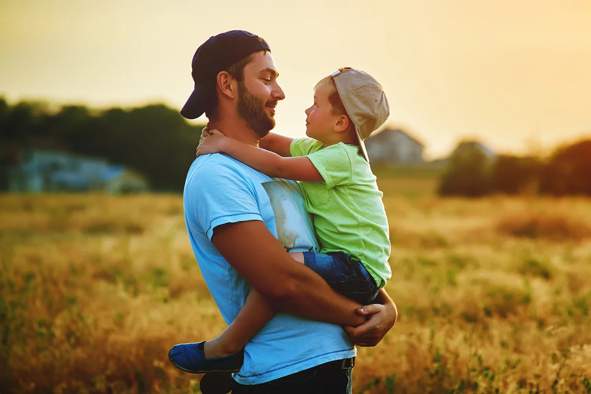Father and son playing and embracing the outdoors