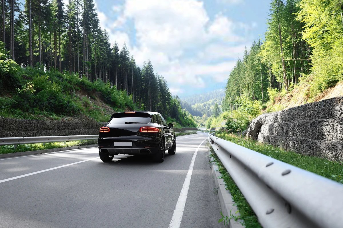 Picturesque view of asphalt road with modern car