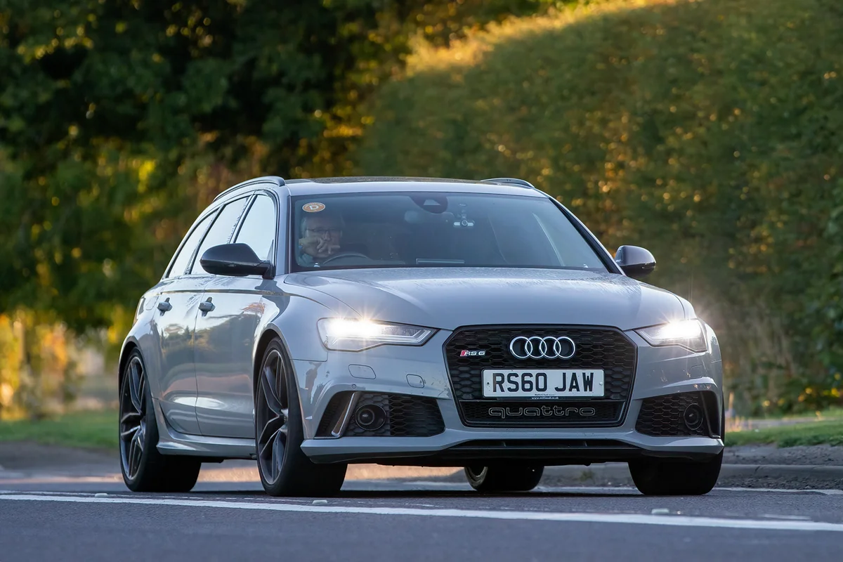 2015 Audi A6 3993 cc car driving on an English country road with headlights on