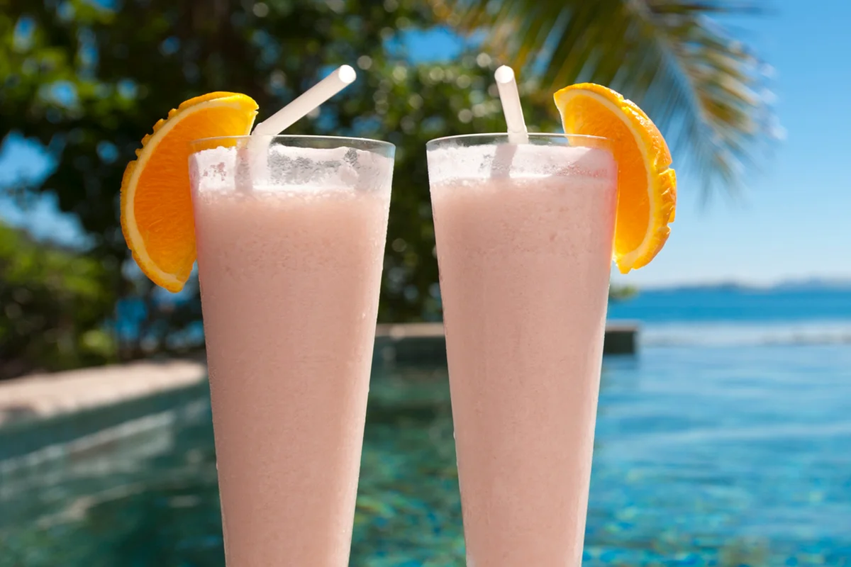 2 cocktails beside a resort swimming pool