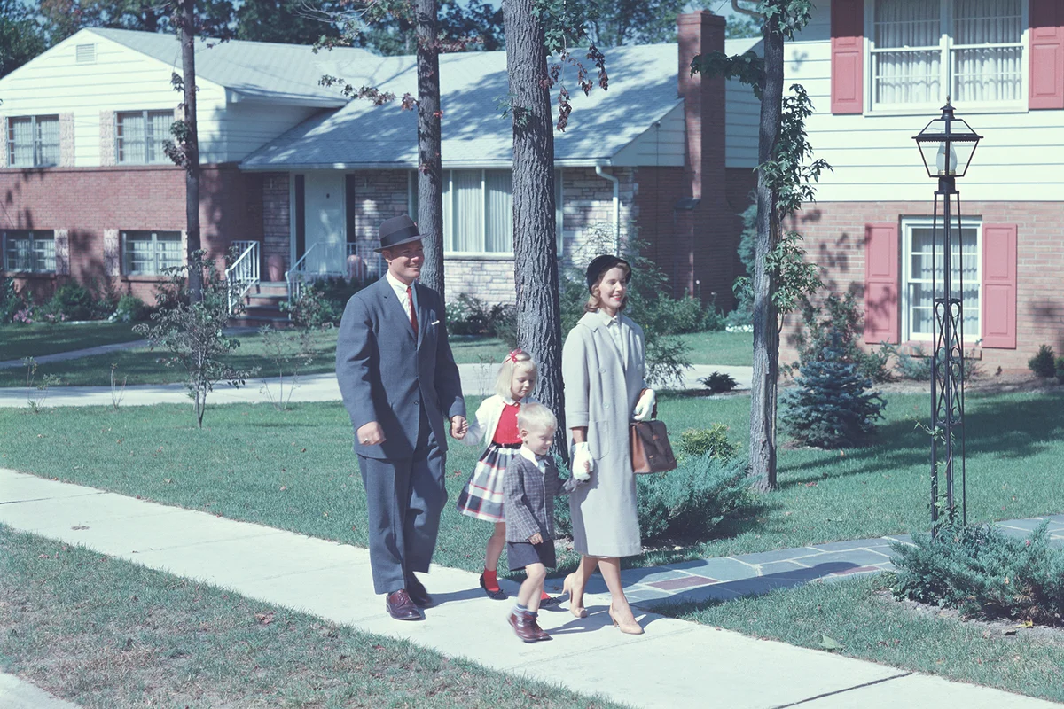 1950s family walking along a sidewalk