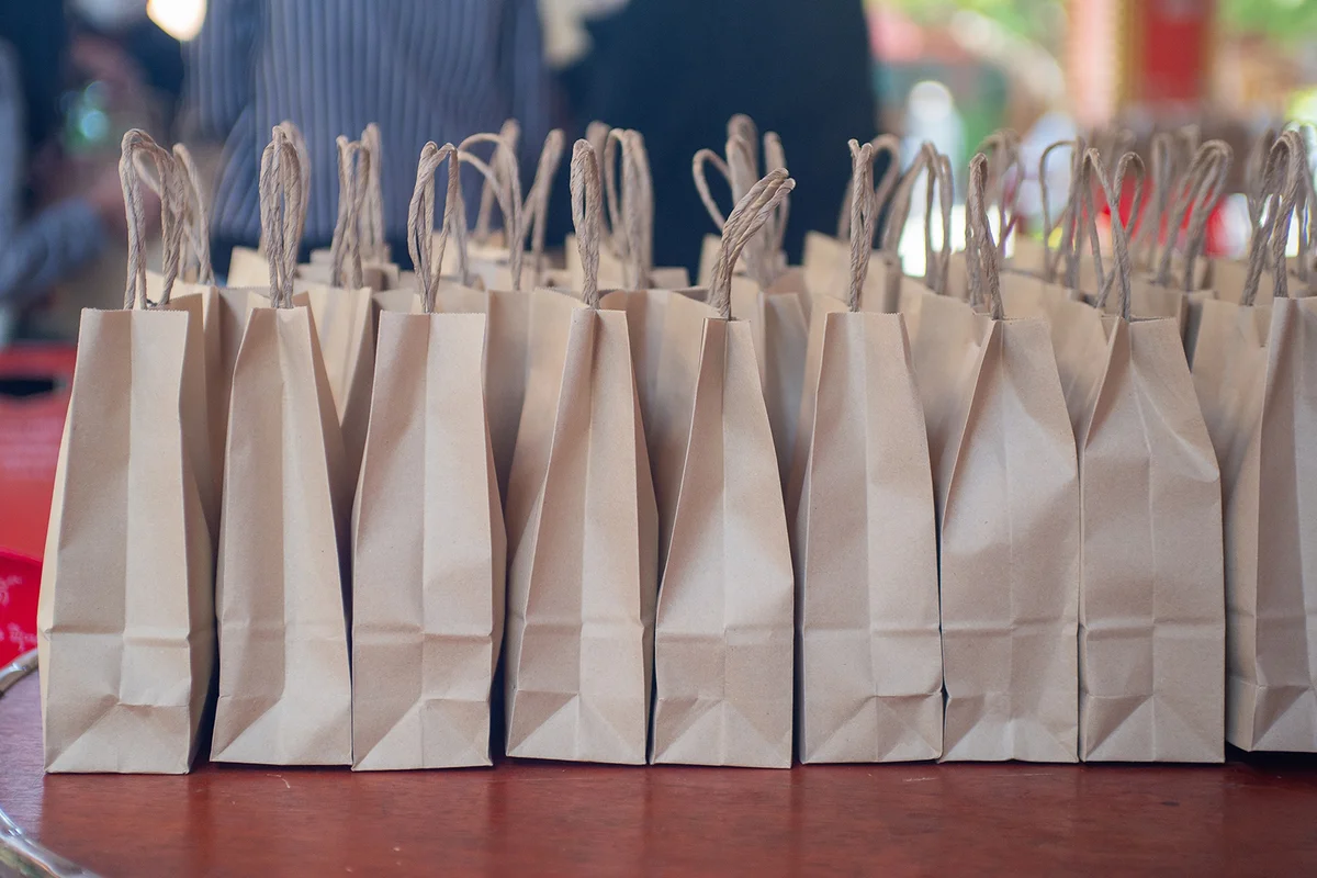 brown paper Goodie bags on a table