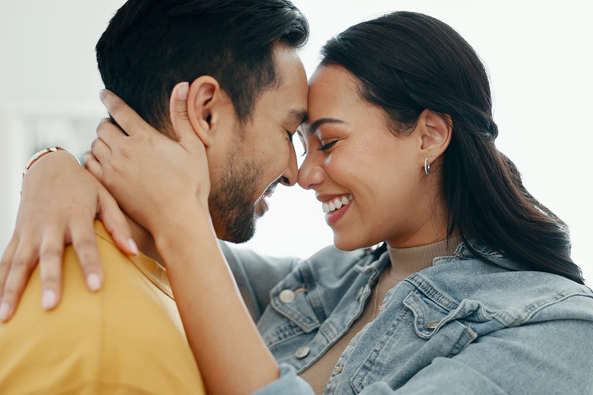 Couple, forehead touch and hug in living room