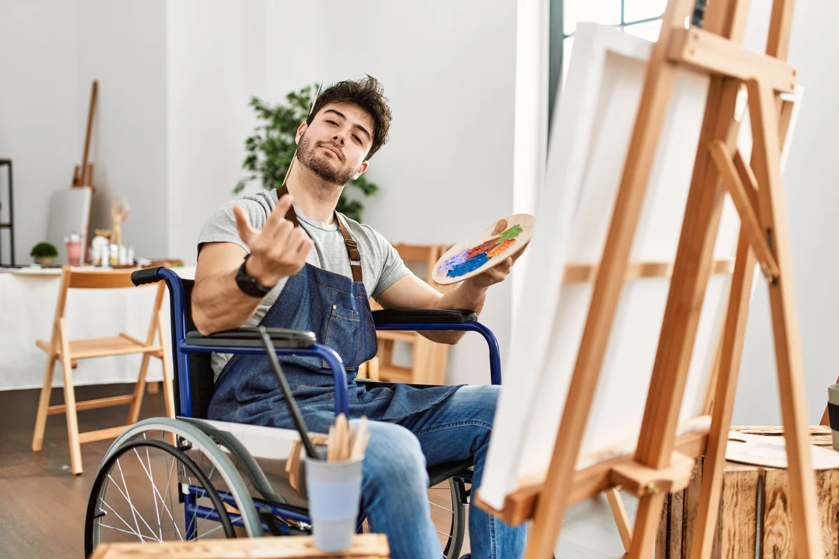 Young man painting at art studio