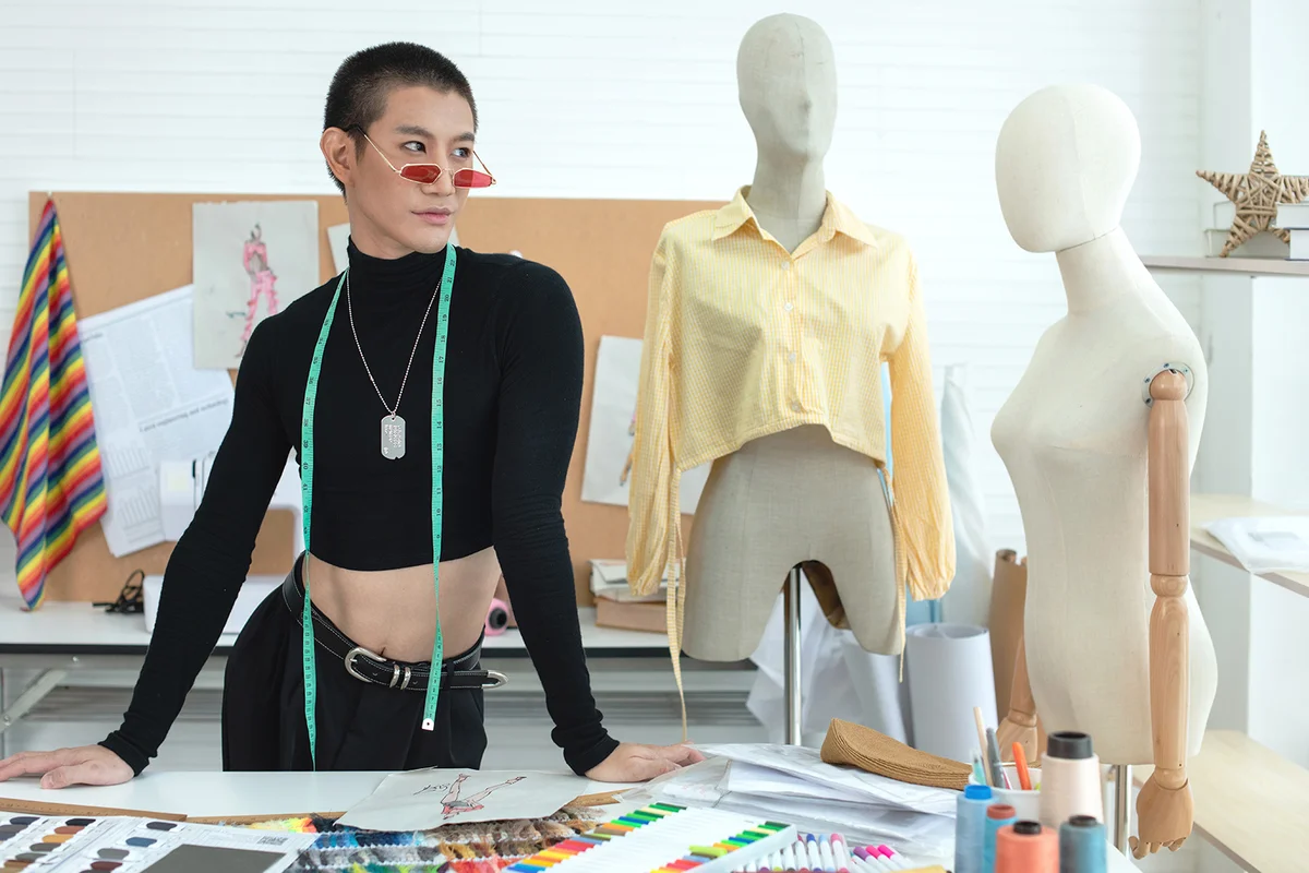 Portrait of person at working desk with tape measure on the neck