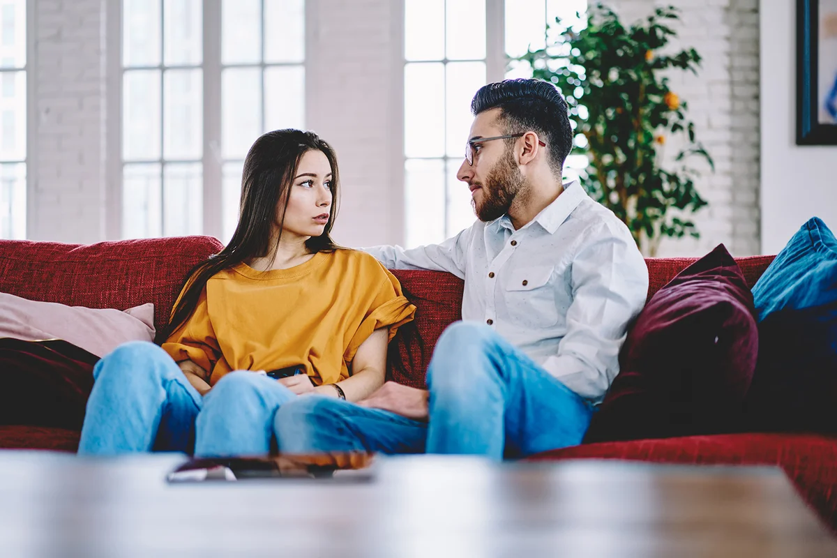 couple discussing plans on couch