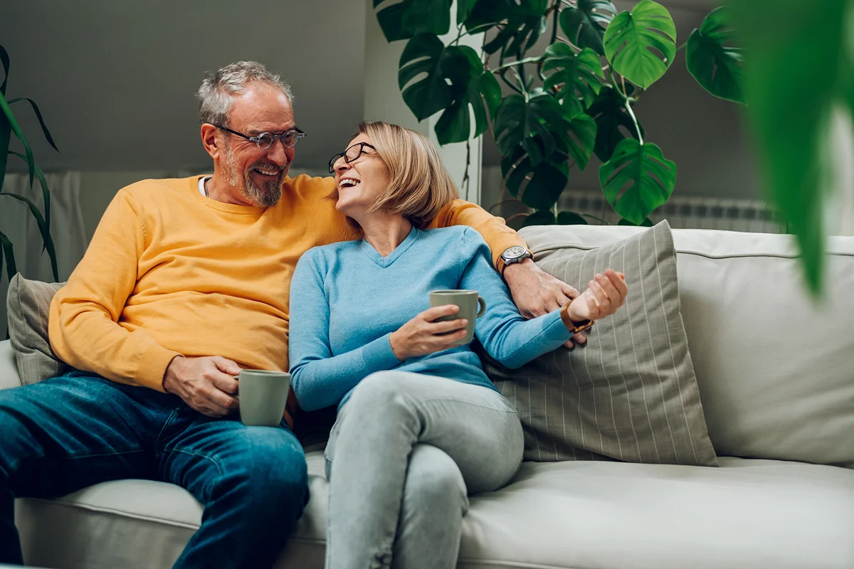happy elderly couple hugging and relaxing together