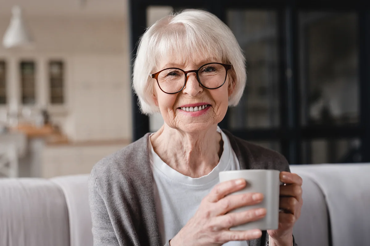 Comfort relaxed senior old elderly woman grandmother drinking tea at home