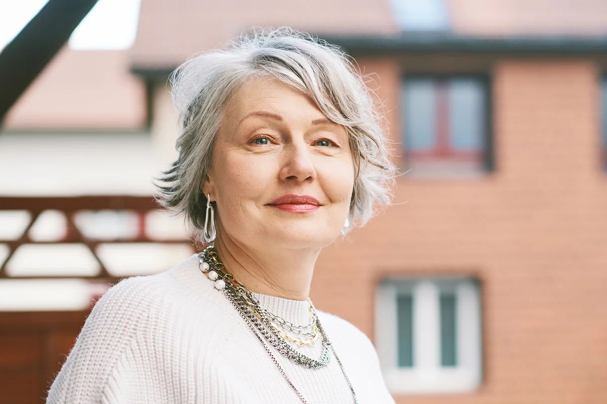 Outdoor close up portrait of beautiful 55 - 60 year old woman