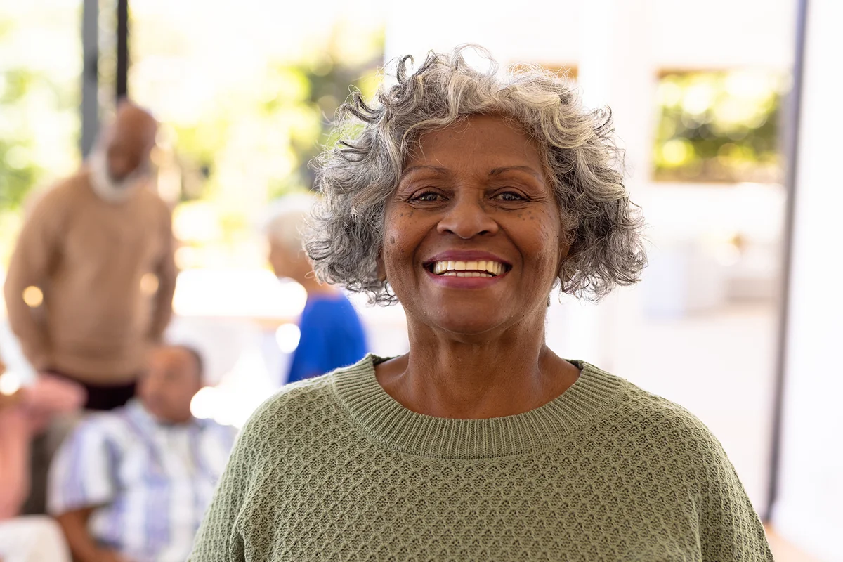 senior woman standing with friends in background